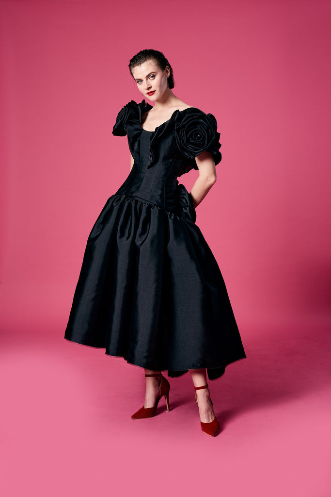 13.	Appliquéd with an oversized organza rose top with ruffled skirt
